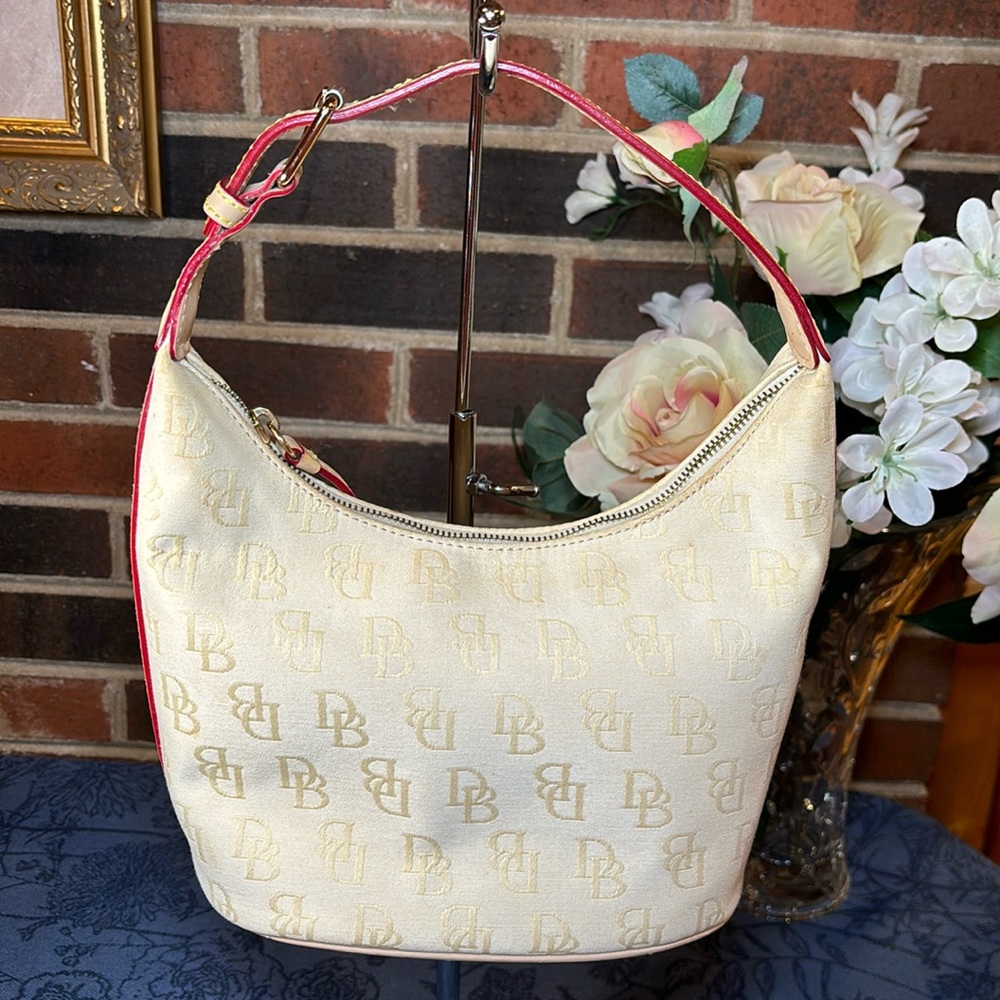 Dooney and Bourke small pale yellow signature bag. 8"L x 8"H x 5.5"W  EUC